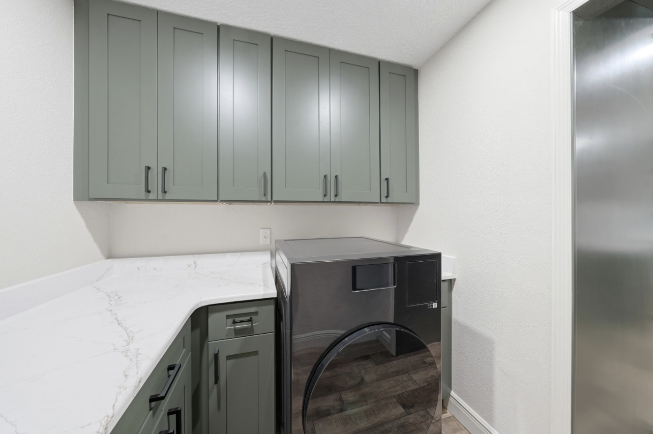 Quartz folding counter and upper cabinets in a remodeled laundry room
