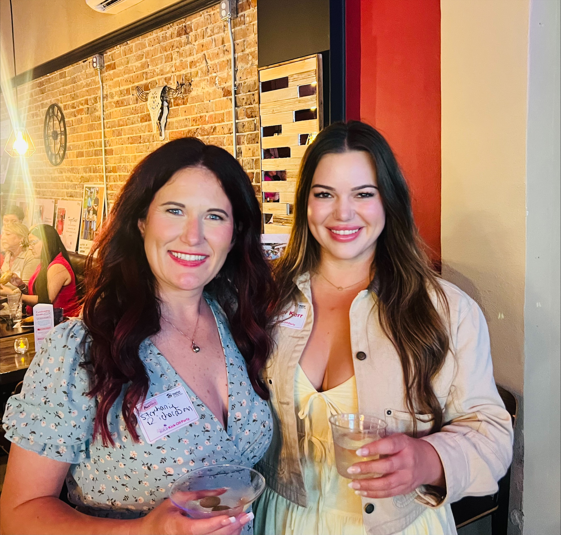 Two DA Construction team members at a Habitat for Humanity Women Build kick-off party