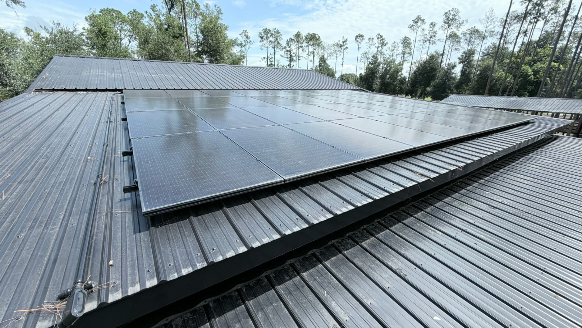 All-black solar array centered on a black metal roof section