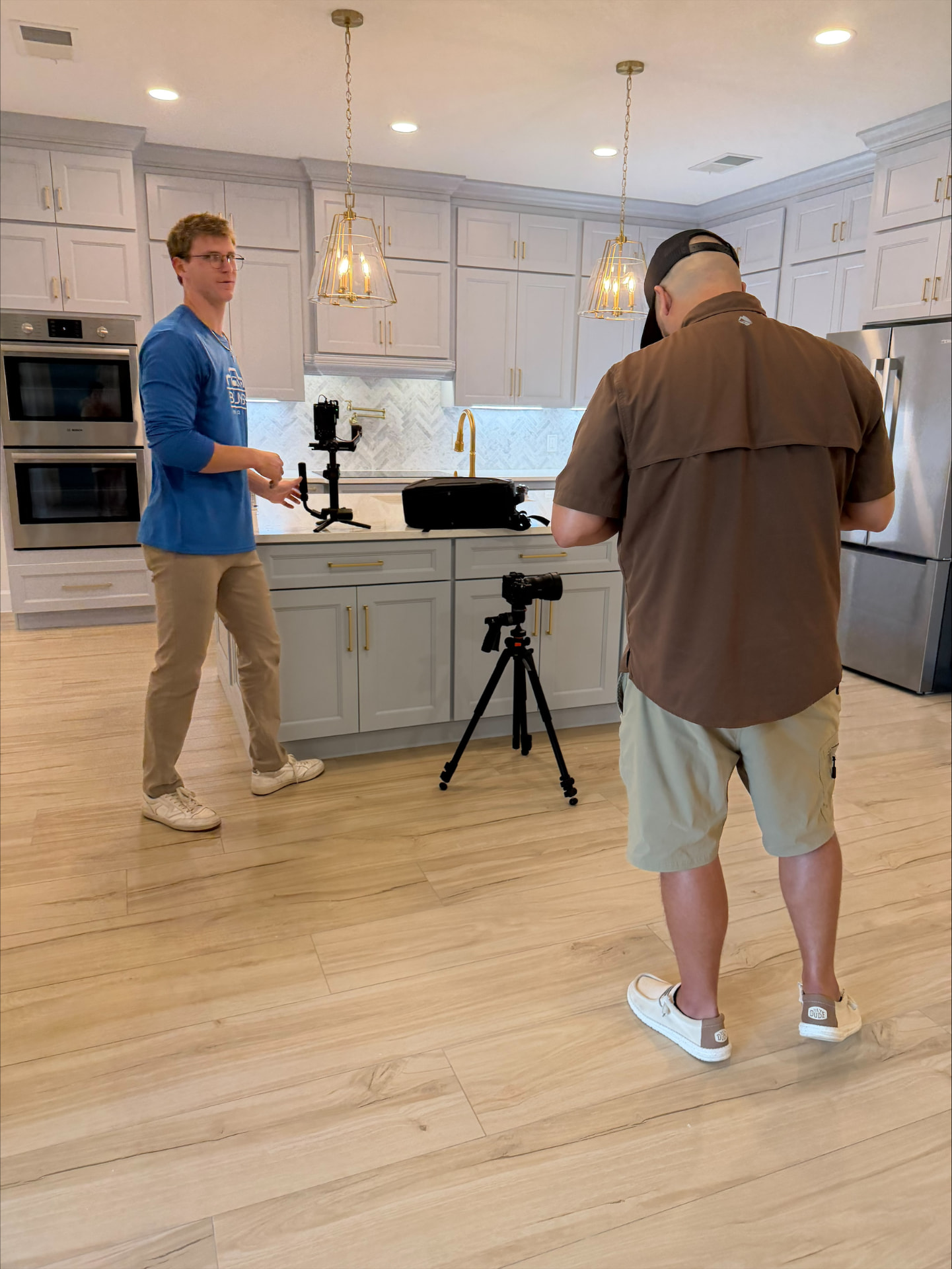 Behind the scenes of a video shoot in a newly completed kitchen