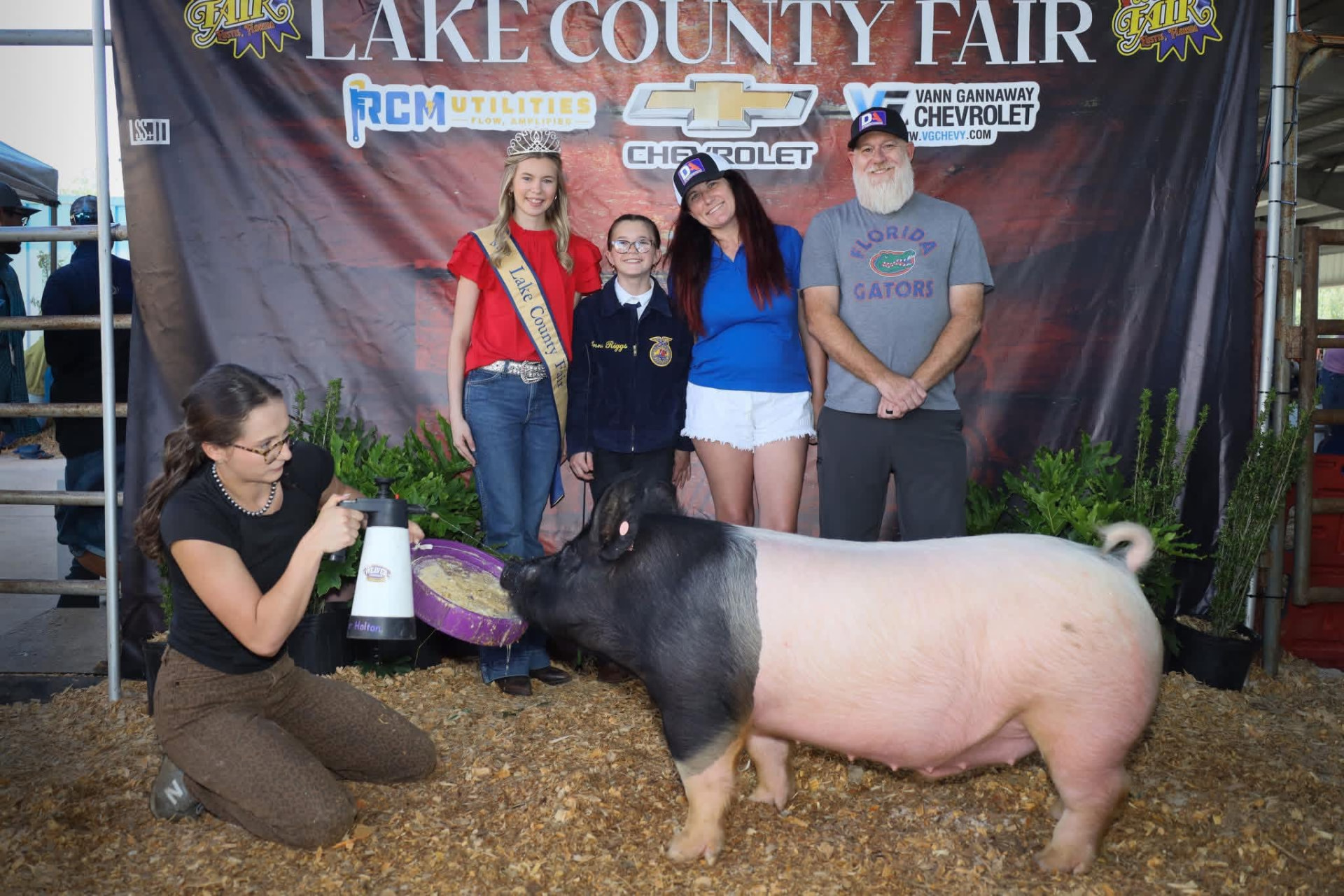 DA Construction team supporting a young exhibitor at the Lake County Fair livestock auction